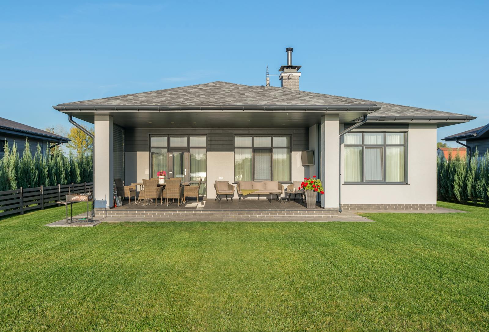 Professional commercial lawn care crew maintaining large Calgary business property with commercial-grade mowing equipment